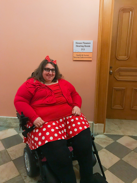 Alicia Hopkins in front of the Subcommittee room