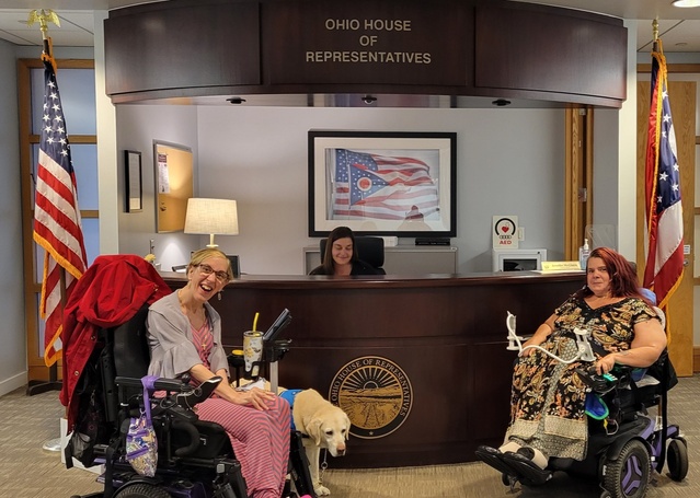 Two wheelchair users, Lisa Marn and Jennifer Kucera, in front of the Ohio House of Representatives