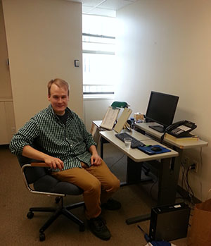 Patrick Meehan sits at the desk in his office at Disability Rights Ohio.