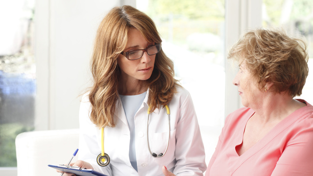 White_woman_doctor_talking_to_patient_cropped